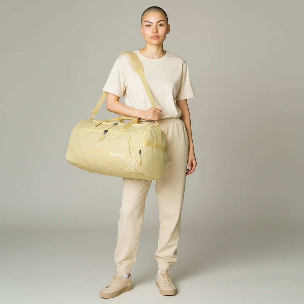 KOFFER-PLUS.COM yellow Travelite Kick Off L 60cm duffel bag with multiple zippered compartments and shoulder strap.